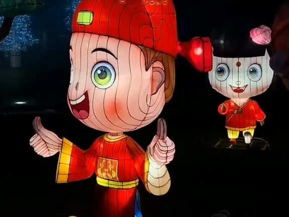 A lantern boy and girl greeting visitors