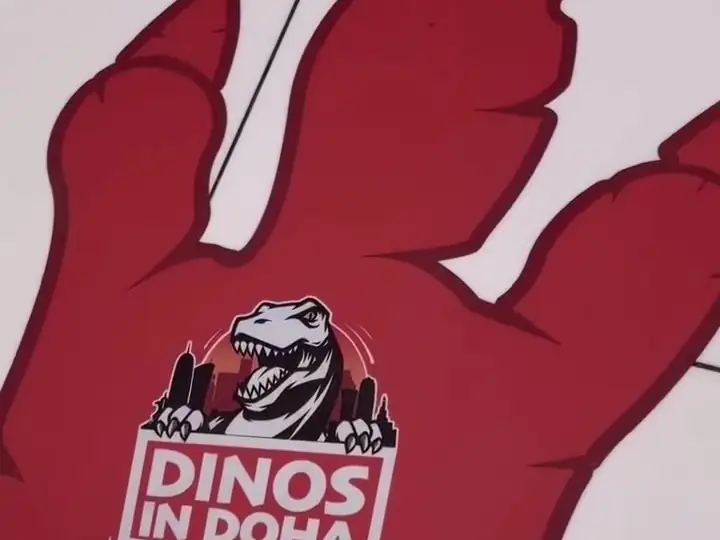 The Dinos in Doha welcome sign