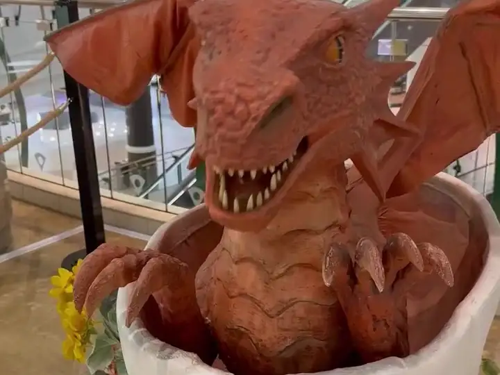 A baby dragon hatching from its egg