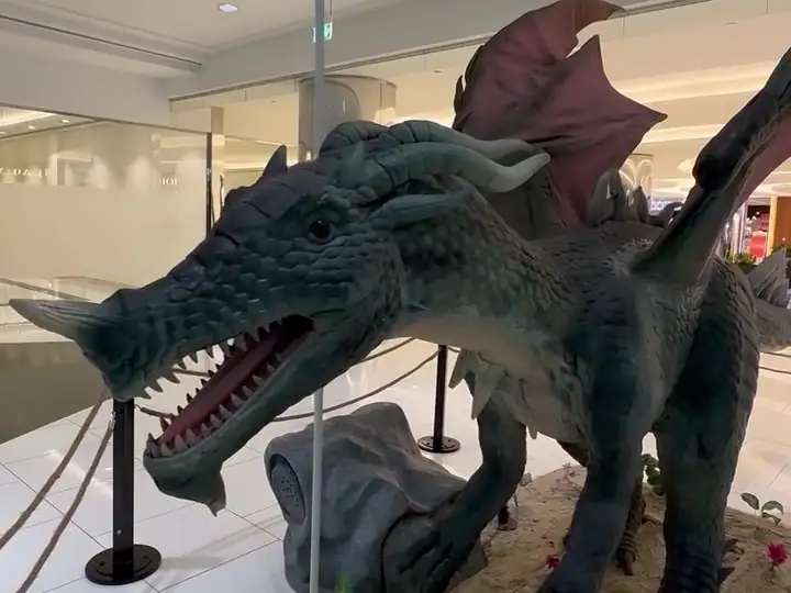 A dark dragon spreading its wings beside the corridor