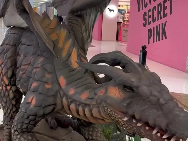 A horned dragon among flowers by the shops